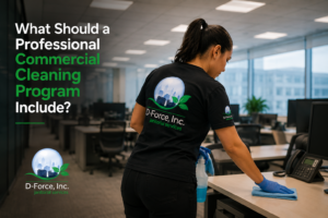 D-Force Janitorial employee disinfecting office desk with microfiber cloth and spray in a modern Miami commercial workspace